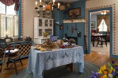 a living room with a table with a table cloth at 1825 Inn Bed and Breakfast in Palmyra