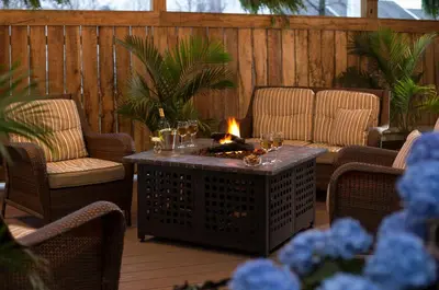 a patio with a table with wine glasses on it at 1825 Inn Bed and Breakfast in Palmyra
