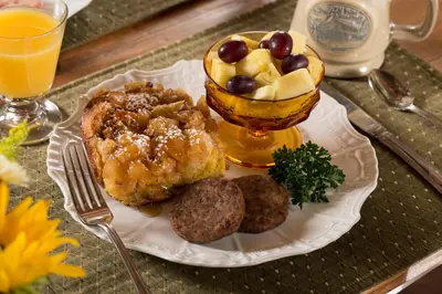 a plate of food with a bowl of fruit and cookies at 1825 Inn Bed and Breakfast in Palmyra