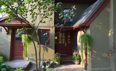 a house with a red door and some potted plants at The Lancaster Bed and Breakfast in Lancaster