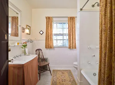a bathroom with a sink and a toilet and a tub at The Lancaster Bed and Breakfast in Lancaster