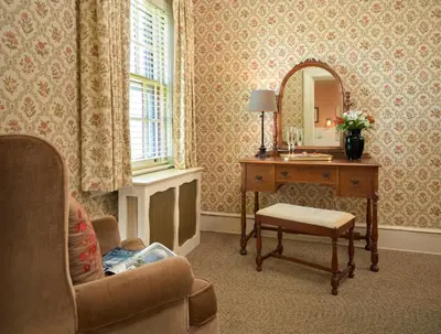 a room with a desk and a mirror and a chair at The Lancaster Bed and Breakfast in Lancaster