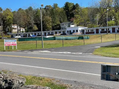 an empty street with a sign on the side of a road at Paramount Motel Pocono in East Stroudsburg