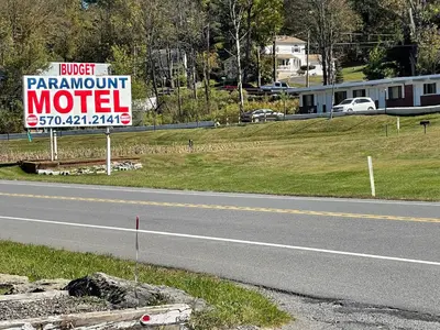 a sign for a motel on the side of a road at Paramount Motel Pocono in East Stroudsburg