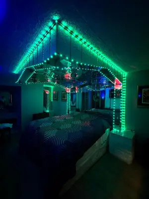 a bedroom with a bed with green and blue lights at Executive Inn Coopersburg in Coopersburg