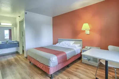 a hotel room with a bed and a desk and a sink at Motel 6-New Cumberland, PA - Harrisburg - Hershey South in New Cumberland