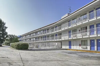 a large white building with blue doors and windows at Motel 6-New Cumberland, PA - Harrisburg - Hershey South in New Cumberland