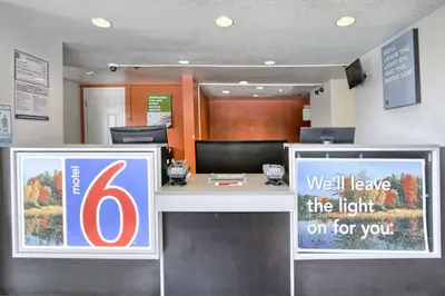 an office with a desk with a sign on it at Motel 6-New Cumberland, PA - Harrisburg - Hershey South in New Cumberland
