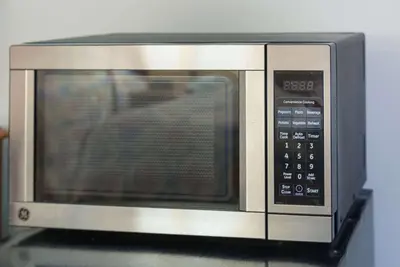 a microwave oven sitting on top of a table at Rodeway Inn Milford - I-84 in Milford