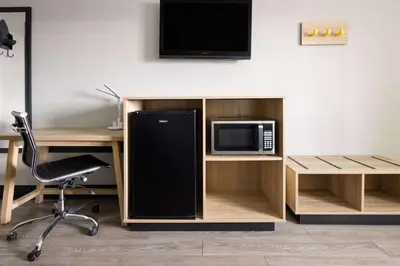 an office with a desk with a microwave and a tv at Super 8 by Wyndham Hazleton in Hazleton