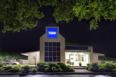 a building with a blue sign on top of it at Travelodge by Wyndham Essington / Philadelphia Airport in Essington