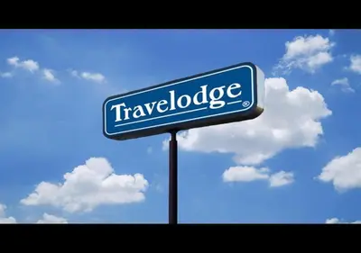 a blue street sign in front of a cloudy sky at Travelodge by Wyndham Essington / Philadelphia Airport in Essington