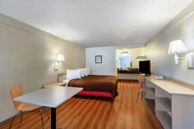 a hotel room with a bed and a desk at Travelodge by Wyndham Essington / Philadelphia Airport in Essington