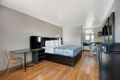 a hotel room with a bed and a kitchen at Motel 6-York, PA in York
