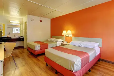 a hotel room with two beds and a kitchen at Motel 6-York, PA in York