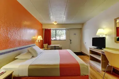 a bedroom with a large bed and a television at Motel 6-York, PA in York
