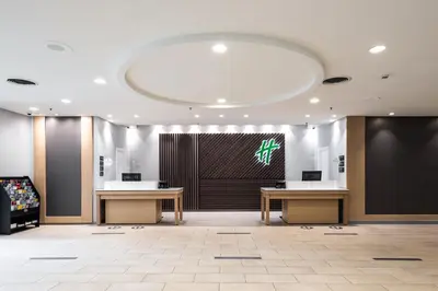 a lobby with two tables and a large screen at Holiday Inn Newark International Airport in Newark