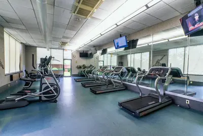 a gym with treadmills and elliptical machines at Holiday Inn Newark International Airport in Newark