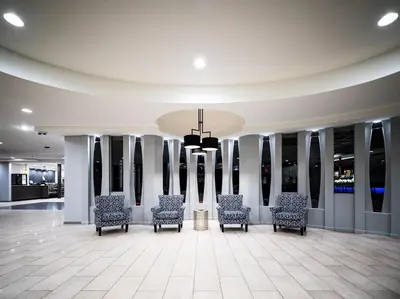 a lobby with chairs and a chandelier at Holiday Inn Newark International Airport in Newark