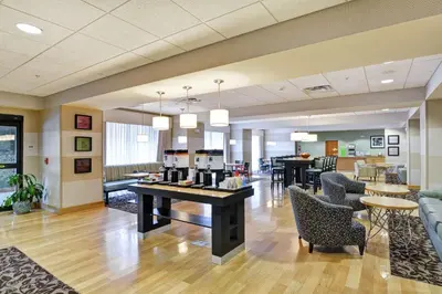 a lobby with chairs and tables and a cafeteria at Hampton Inn Tunkhannock in Tunkhannock