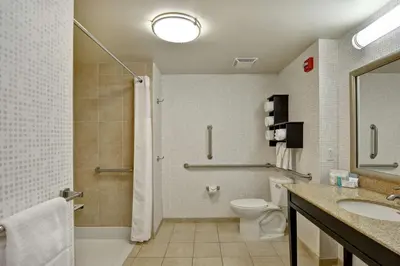 a bathroom with a toilet and a sink and a shower at Hampton Inn Tunkhannock in Tunkhannock
