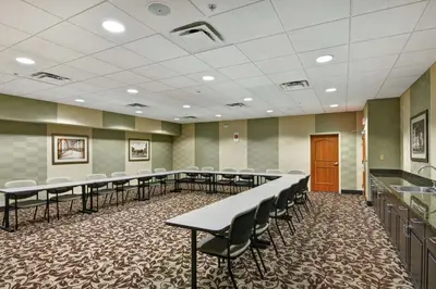 a conference room with rows of tables and chairs at Hampton Inn Tunkhannock in Tunkhannock
