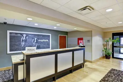 an office lobby with a large tv on the wall at Hampton Inn Tunkhannock in Tunkhannock