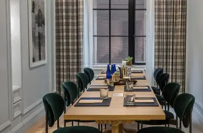 a conference room with a long table and chairs at Merrion Row Hotel and Public House in New York