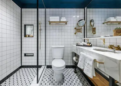 a bathroom with a toilet and a sink at Merrion Row Hotel and Public House in New York