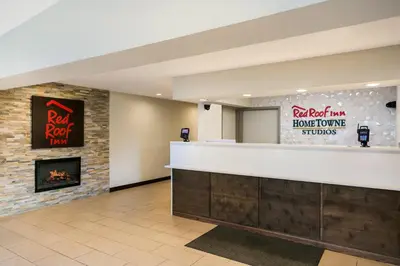 a lobby with a bar and a fireplace at Red Roof Inn Denver in Denver