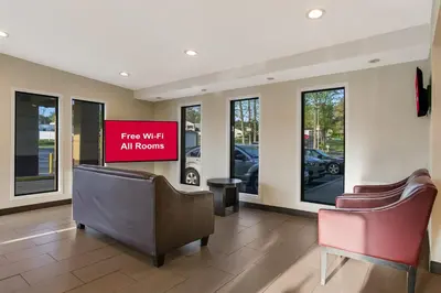 a waiting room with two chairs and a sign that reads fire wifi all rooms at Red Roof Inn Denver in Denver