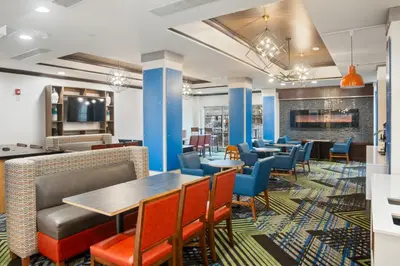 a dining room with tables and chairs at Holiday Inn Express and Suites Stroudsburg-Poconos by IHG in Stroudsburg