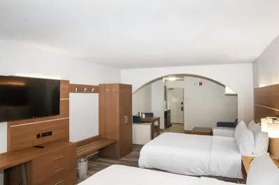 a hotel room with two beds and a flat screen tv at Holiday Inn Express and Suites Stroudsburg-Poconos by IHG in Stroudsburg