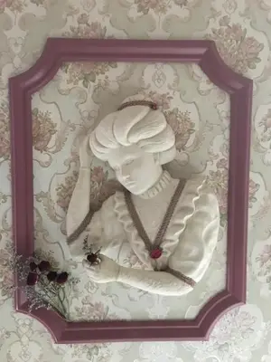 a statue of a woman in a frame on a wall at Carriage Stop Bed & Breakfast in Palmyra