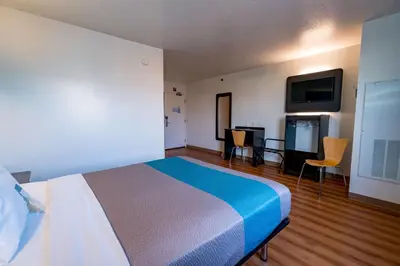 a hotel room with a bed and a flat screen tv at Motel 6-Pottstown, PA in Pottstown