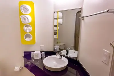 a bathroom with a sink and a mirror at Motel 6-Pottstown, PA in Pottstown