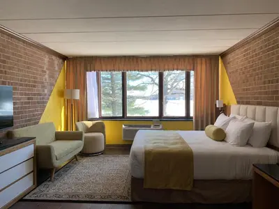 a hotel room with a bed and a television at Split Rock Resort in Lake Harmony