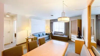 a living room with a table and a couch at Split Rock Resort in Lake Harmony