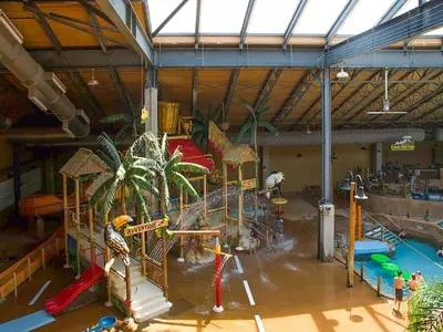 a large indoor water park with a water slide at Split Rock Resort in Lake Harmony