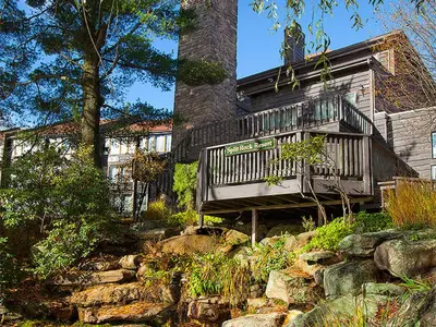 a house with a balcony on the side of it at Split Rock Resort in Lake Harmony