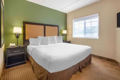 a large bed in a hotel room with a window at Extended Stay America Suites - Secaucus - New York City Area in Secaucus
