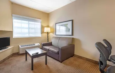 a living room with a couch and a tv at Extended Stay America Suites - Secaucus - New York City Area in Secaucus