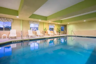 a swimming pool with lounge chairs and a pool at Holiday Inn Express and Suites Quakertown - Allentown Area by IHG in Quakertown
