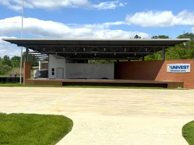 a building with awning in front of a parking lot at Holiday Inn Express and Suites Quakertown - Allentown Area by IHG in Quakertown