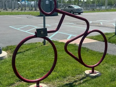 a statue of two large metal hoops on the grass at Holiday Inn Express and Suites Quakertown - Allentown Area by IHG in Quakertown