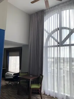 a room with a table and chairs and a large window at Holiday Inn Express and Suites Quakertown - Allentown Area by IHG in Quakertown
