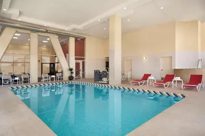 a swimming pool in a hotel with chairs and tables at Homewood Suites University City Philadelphia in Philadelphia