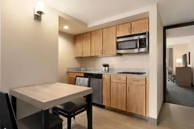 a small kitchen with a table and a microwave at Homewood Suites University City Philadelphia in Philadelphia