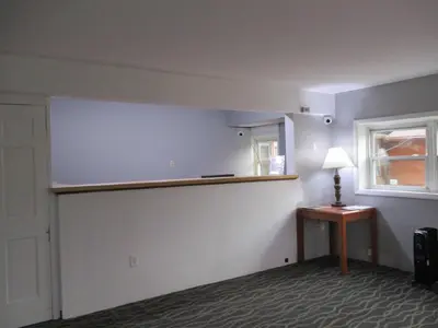 an empty room with a lamp on a table and a window at Motel 6-Shartlesville, PA in Shartlesville