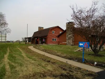 a barn with a sign in front of it at Motel 6-Shartlesville, PA in Shartlesville